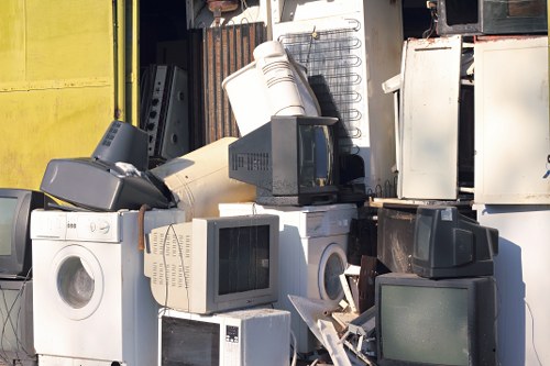 Workers disposing of old furniture responsibly